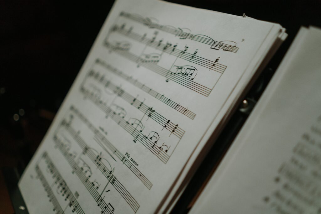 Close-up of sheet music displaying musical notes on a stand, perfect for musical compositions and practice.