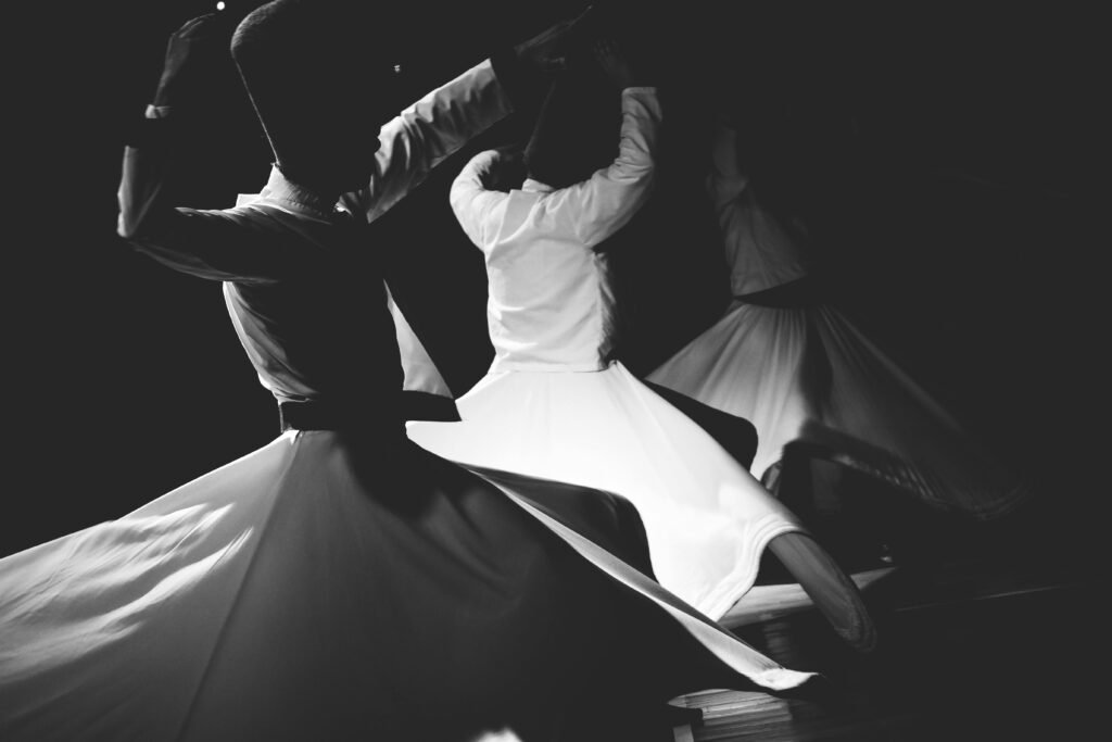Musik untuk koreografi | Monochrome image capturing traditional Whirling Dervishes in motion, embodying mysticism and cultural heritage.